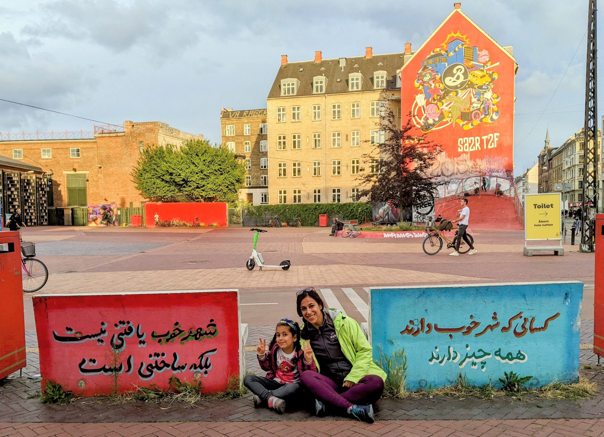 Woman and kid sitting in a beautiful city landscape